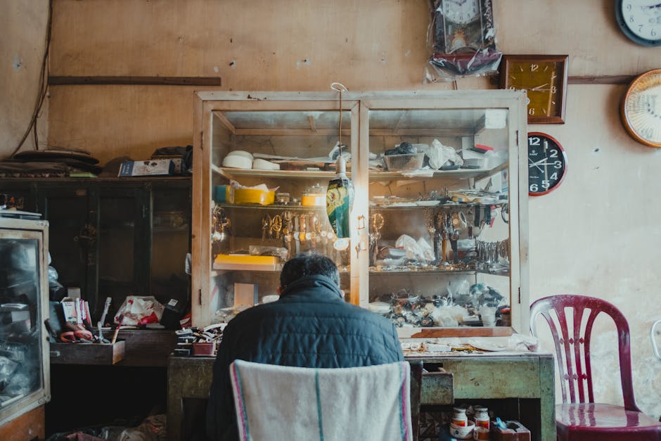 A dedicated craftsman meticulously repairing watches in a vintage shop filled with clocks.