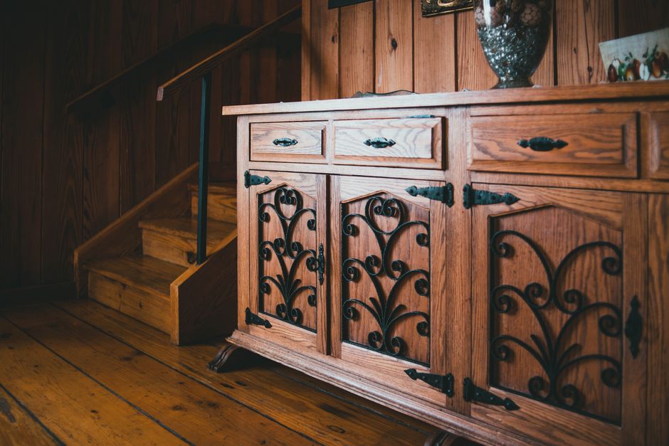 Warm wooden sideboard and staircase in a cozy, rustic interior.